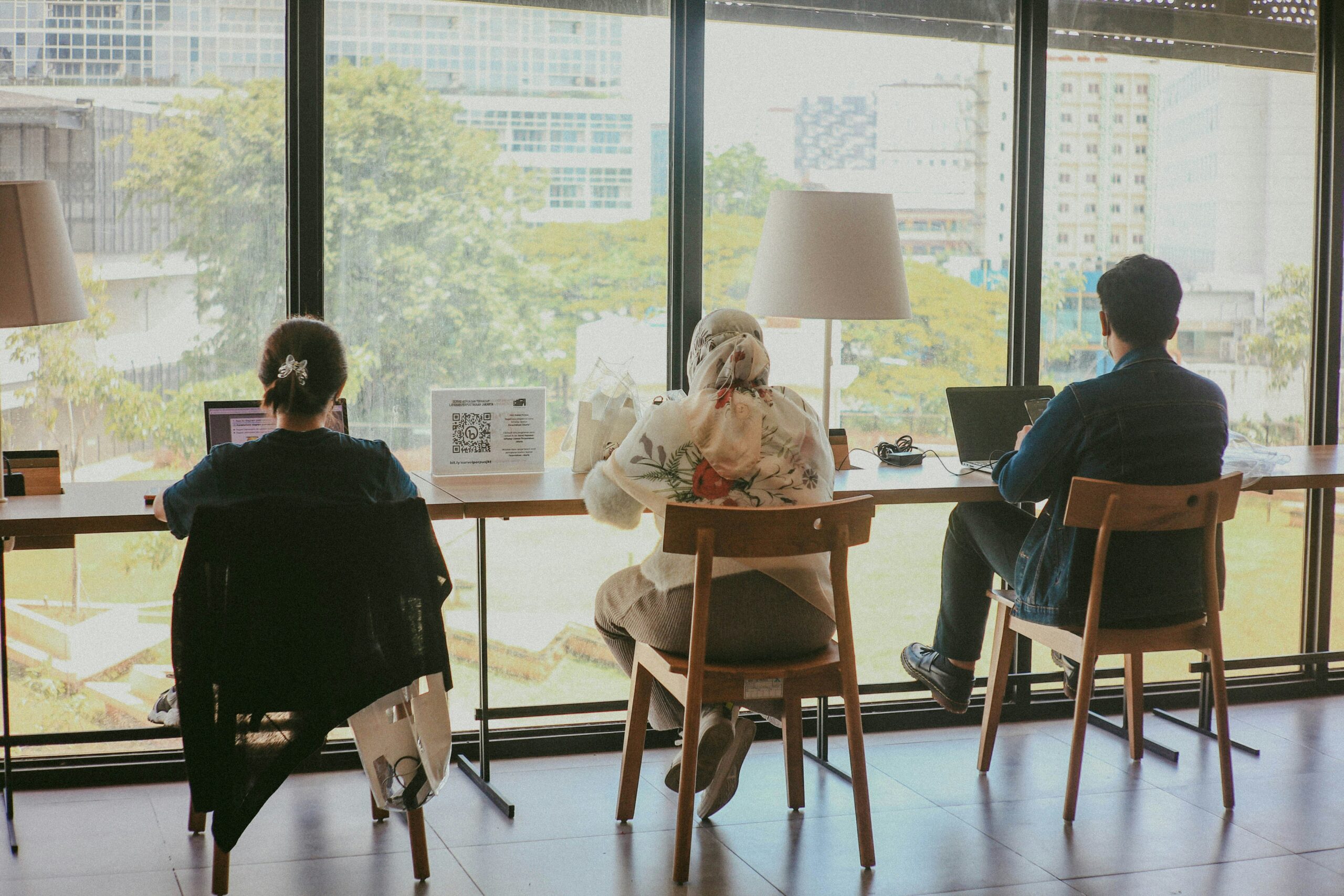 a couple of people sitting at a table in front of a window